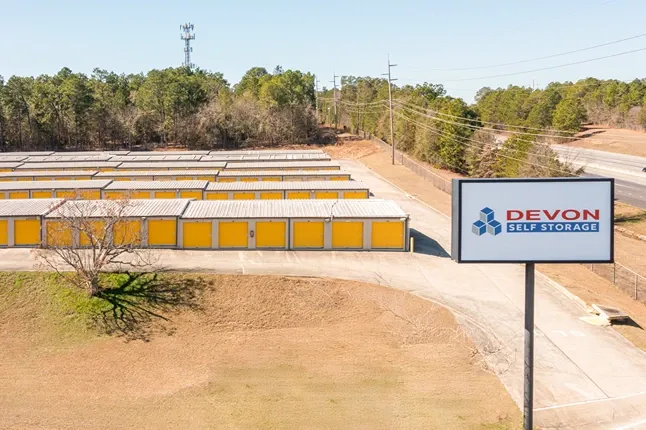Self storage facility with visible roadside signage and rows of outdoor storage units